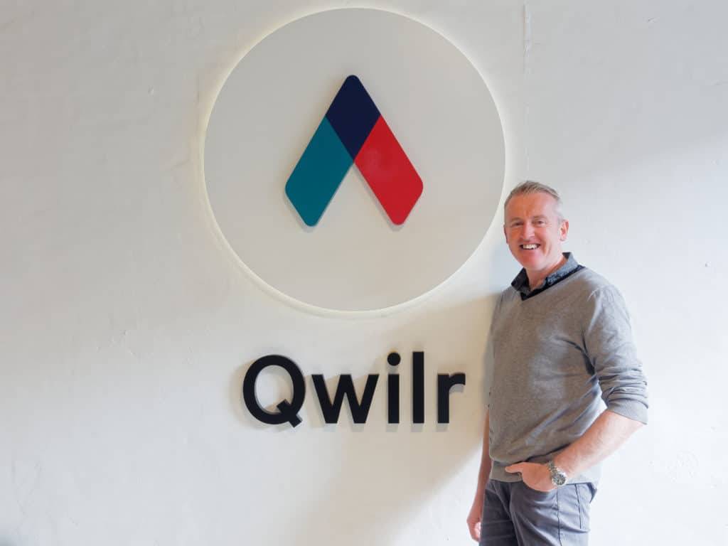 Ben Mackie joins Qwilr - in front of logo 